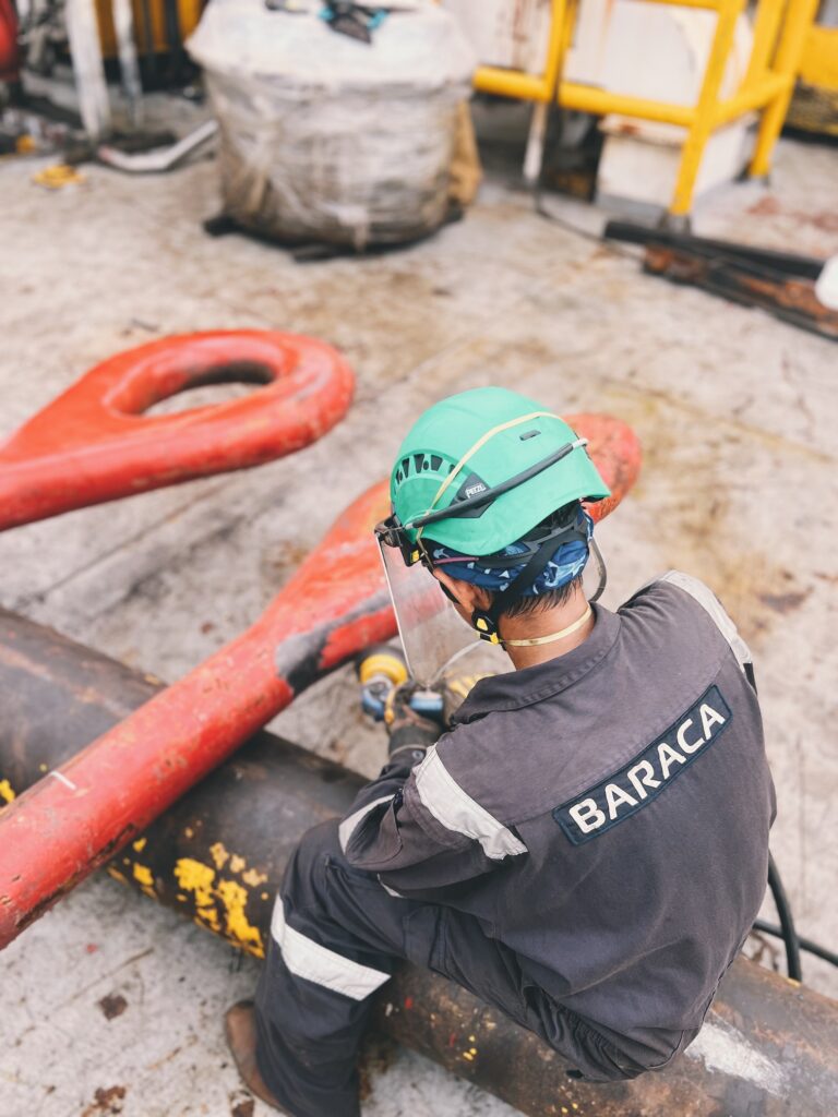 BTS technician inspecting a lifting point on a vessel deck